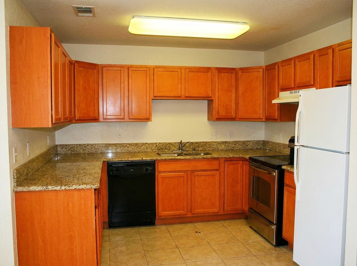 Dated builder-grade maple kitchen before remodeling
